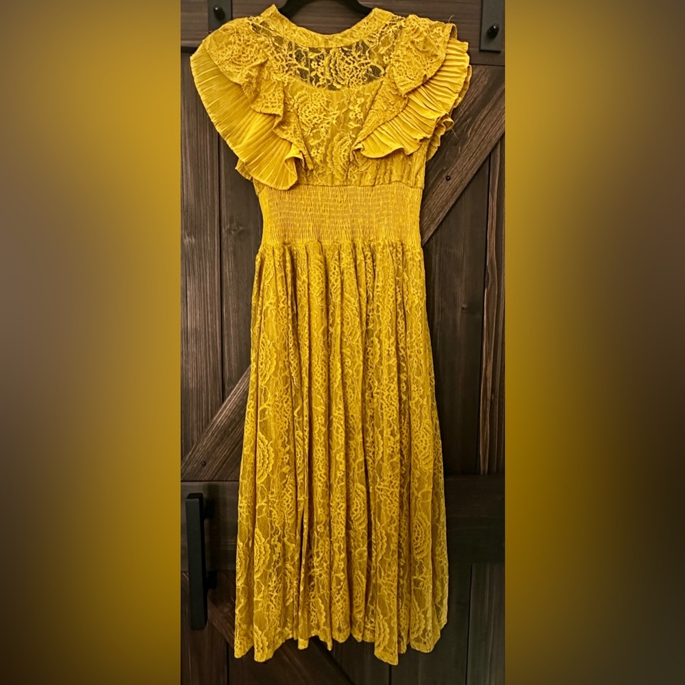 Gorgeous lace dress. Elastic mid waist and falls right below the knees.
